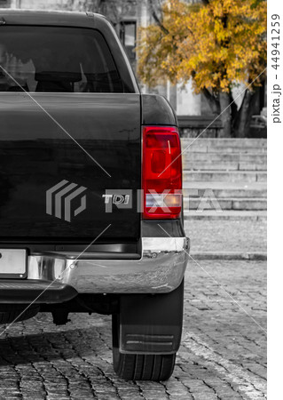 large SUV rear view. against a backdrop of granite steps and wood 44941259