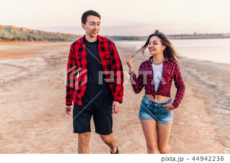 oung couple on the beach walking together 44942236