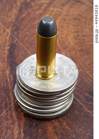Revolver cartridge and Silver Dollars 44943616