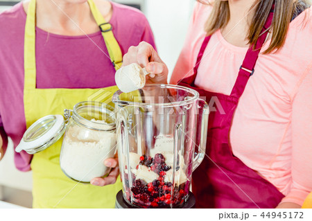 Friends making fruit milkshake Friends making fruit milkshake 44945172