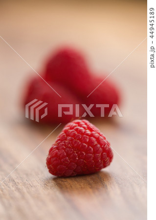 Ripe raspberries on wood background Ripe raspberries on wood background 44945189
