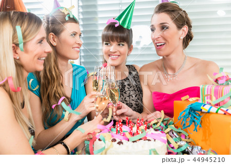 Four beautiful and cheerful women toasting with champagne 44945210