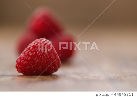 Ripe raspberries on wood background Ripe raspberries on wood background 44945211