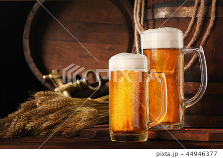 Two mugof beer .With wheat and barley and barrel Two mugof beer .With wheat and barley and barrel 44946377