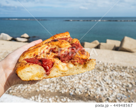 Piece of fresh, fragrant, ruddy Neapolitan pizza Piece of fresh, fragrant, ruddy Neapolitan pizza 44948567