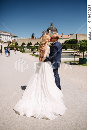 Beautiful young bride with her handsome groom walking in palace Belvedere 44949088