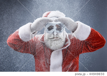 Frozen Santa Claus in protective glasses searching the road 44949650