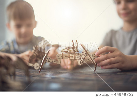 Close up of creative children making wooden figures together 44949755