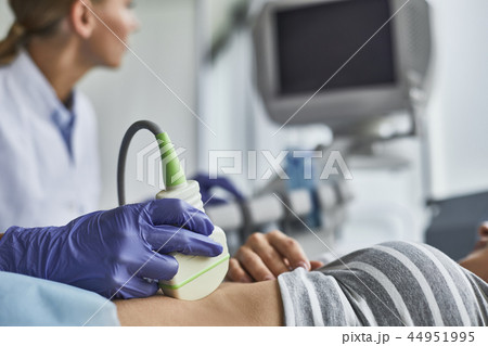 Doctor checking woman pregnancy during sonography examination Doctor checking woman pregnancy during sonography examination 44951995