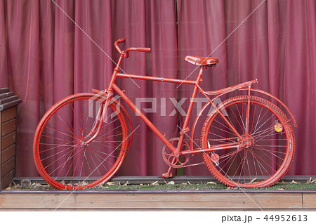 Red bicycle and a background of a fandango color. 44952613