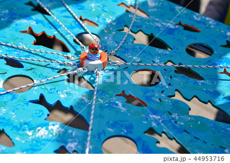 A group of teenagers play a board game on street 44953716