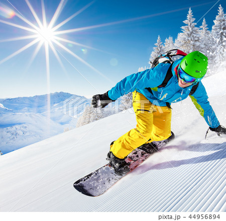 Man snowboarder riding on slope. Man snowboarder riding on slope. 44956894
