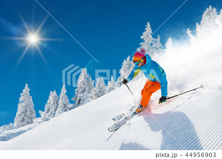 Skier skiing downhill in high mountains Skier skiing downhill in high mountains 44956903