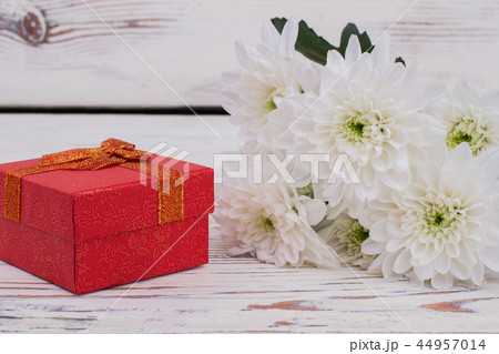 Bouquet of flowers and red gift box. 44957014
