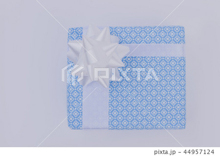 Light blue gift box with white bow. Light blue gift box with white bow. 44957124