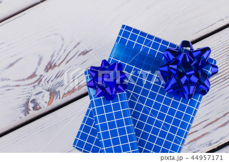 Christmas gift boxes on white wooden background. Christmas gift boxes on white wooden background. 44957171