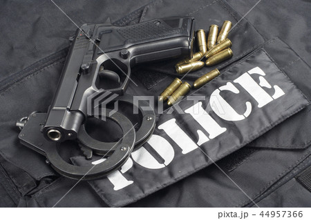 Police concept - handgun on black uniform Police concept - handgun on black uniform 44957366