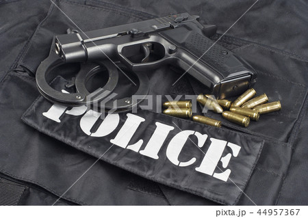 Police concept - handgun on black uniform  44957367