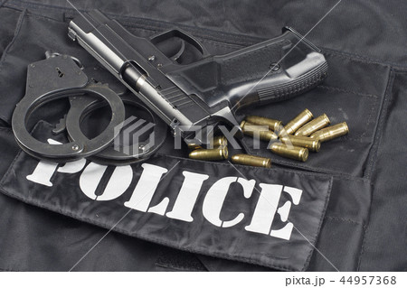 Police concept - handgun on black uniform Police concept - handgun on black uniform 44957368