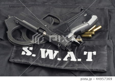 SWAT teams concept -handgun on black uniform  44957369