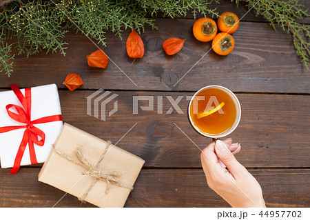 Christmas background with gifts and Christmas tree tea cup fruit 44957702