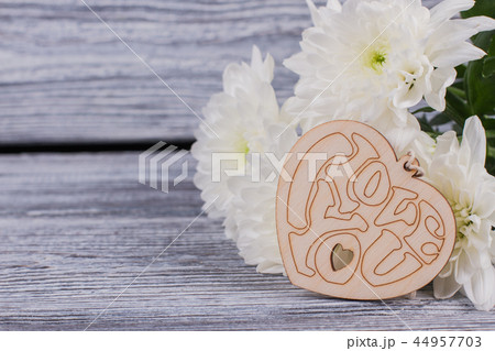 Bouquet of flowers and wooden heart. 44957703