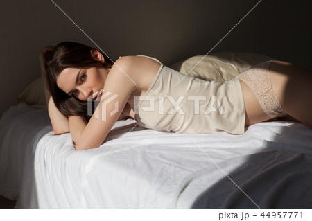 beautiful woman in underwear lies on the bed in the bedroom tonight beautiful woman in underwear lies on the bed in the bedroom tonight 44957771