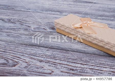 Jewelry gift box on gray wooden background. 44957786