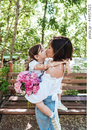 Mom is holding his little daughter in the park Mom is holding his little daughter in the park 44957825