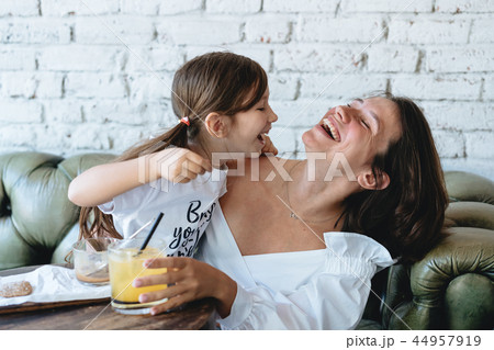 Mom and her little girl have fun on the couch 44957919