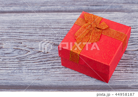 Red gift box on wooden background. Red gift box on wooden background. 44958187