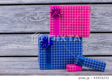 Colorful wrapped gift boxes on wooden background. Colorful wrapped gift boxes on wooden background. 44958242