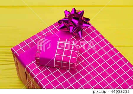 Big and small gift boxes on color background. Big and small gift boxes on color background. 44958252