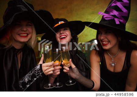 Image of three happy witches with glass with wine 44958596
