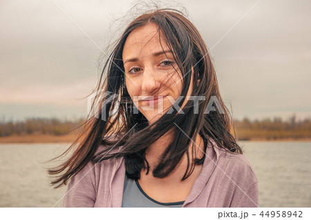 Romantic girl with wind in hair looking at camera 44958942