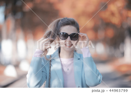 autumn girl / portrait of a girl in an autumn city park, walk happy weekend female portrait 44963799