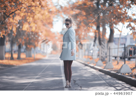 walk in autumn park / beautiful girl in autumn park, model female happiness and fun in yellow trees October walk in autumn park / beautiful girl in autumn park, model female happiness and fun in yellow trees October 44963907