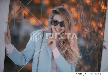 walk in autumn park / beautiful girl in autumn park, model female happiness and fun in yellow trees October 44964106