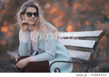 walk in autumn park / beautiful girl in autumn park, model female happiness and fun in yellow trees October 44964439