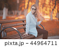 walk in autumn park / beautiful girl in autumn park, model female happiness and fun in yellow trees October 44964711