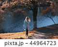 walk in autumn park / beautiful girl in autumn park, model female happiness and fun in yellow trees October 44964723