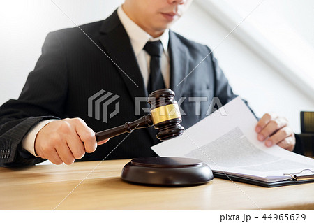 tribunal Attorney lawyer working with documents and wooden gavel tribunal Attorney lawyer working with documents and wooden gavel 44965629