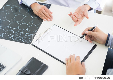 doctor giving a consultation discussing to patient and explainin 44965630