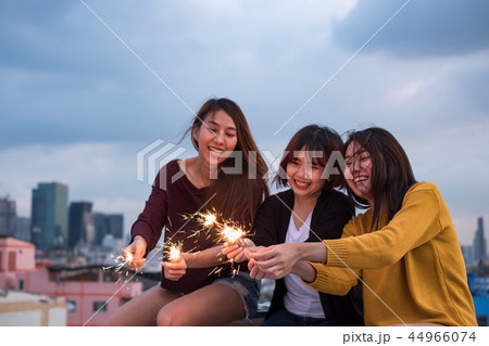 Happy group of asian girl friends play sparkler Happy group of asian girl friends play sparkler 44966074