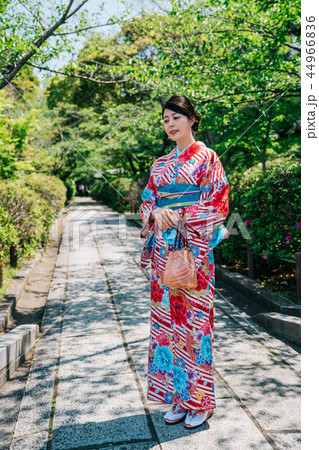 lady with colorful kimono standing in garden 44966836