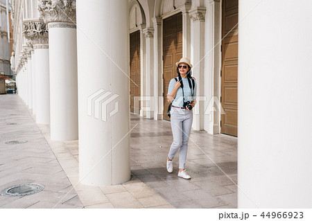 lady walking in the Greek style building lady walking in the Greek style building 44966923