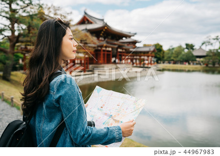 traveler standing near the pond looking at view traveler standing near the pond looking at view 44967983