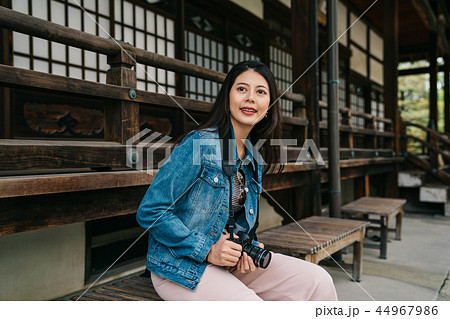 asian photographer sitting on the bench asian photographer sitting on the bench 44967986