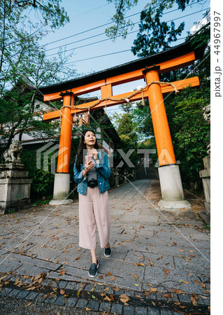 asian traveler walking pass the Torii asian traveler walking pass the Torii 44967997