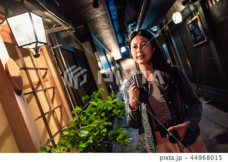 a beautiful lady walking alone on a path at night 44968015